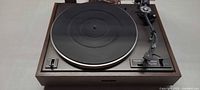Full view of Pioneer PL-120 turntable showing platter, tonearm, controls and wood plinth