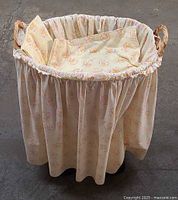 Top view of wicker bassinet with fabric liner and skirt
