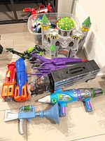 Lot overview showing castle playset, vehicles, blaster and megaphone