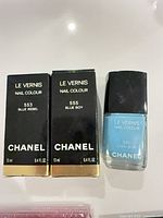 Front view of two Chanel nail polish boxes 553 and 555 with bottle displayed
