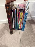 Spine view of all eleven books standing together