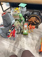 Group shot of volcano, figures, jeep, carry case, tower and bin