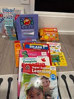 Group shot showing boxed Bob Books, First Little Readers set, Brain Quest deck and stacked workbooks