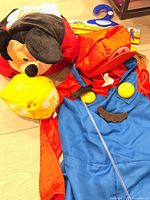 Mickey Mouse headpiece, Mario costume pieces including cap and buttons