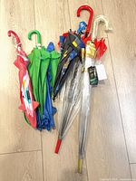 All five umbrellas grouped showing handles, canopies, colours