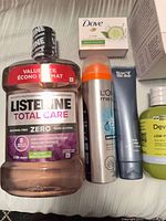 Listerine, Dove bar, L’Oréal Men Expert aerosol, Sky for Men tube, DevaCurl bottle group visible