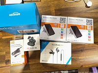 Group shot showing Echo Show 5 box, two mini routers, Anker earphones, iQ budz Q2, iQ Mobile Power