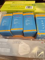 Blue urine test strip boxes, green COVID test box, CA-N95 mask