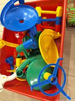 Top view of red bin holding multicolour marble run parts