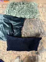 Four decorative pillows on rug