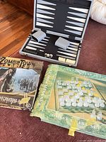 three boxed/loose games: backgammon open, glass chess set box, Zombietown box