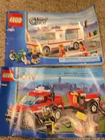 Two LEGO City instruction manuals: ambulance 4431 and off-road fire truck with trailer