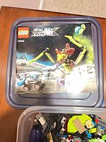Lid showing LEGO Galaxy Squad 70703 artwork
