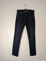Full front view of jeans hanging