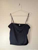 Front view of dark navy Sunday Best blouse on hanger