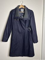 Front view of navy wool coat with grey collar and belt