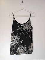Front view of black floral Babaton blouse on hanger