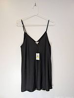 Full front view of black Calvin Klein tank top on hanger
