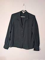 Full front view of blouse on hanger