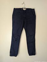 Full view of navy pants hanging front side