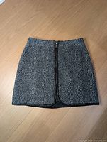 Front view of Highline Collective black/gray fleece skirt with zipper