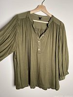 Front view of olive J.Crew blouse on hanger