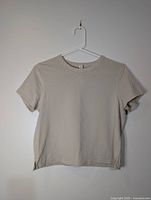 Front view of beige Lululemon T-shirt on hanger