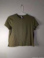 Front view of green Lululemon T-shirt on hanger