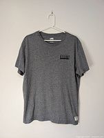 Full front view of grey Roots T-shirt on hanger