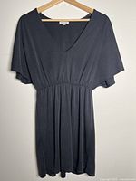 Front view of charcoal V-neck dress on hanger