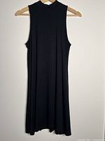 Front view of black sleeveless dress on hanger