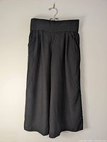 Front view of Talula black wide-leg capri pants hanging