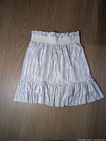 Full view of pleated gold skirt front