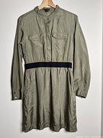 Front view of olive green Theory dress showing chest pockets, waistband, overall style