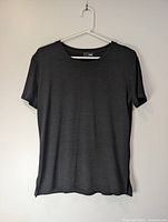Front view of black short-sleeve shirt hanging on hanger