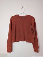 Front view of ribbed orange Wilfred Free top on hanger