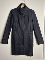Front view of black Zara Basic coat on hanger