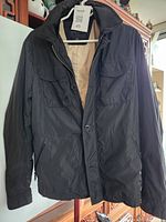 Front view of jacket hanging, shows overall appearance and front details
