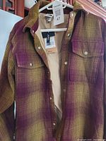 Front of jacket open showing lining, pockets, tags