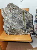 Front view of schist rock showing large epidote vein at center