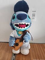 Front view of 16-inch Stitch Elvis plush with guitar