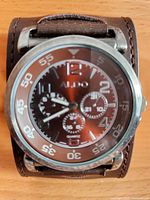 Front view of Aldo watch showing dial, case and leather cuff strap