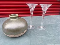 Overall view of two crystal candle holders and ceramic vase