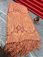 Paisley blanket and glass paperweight together