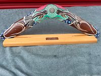 Front view of painted boomerang on stand