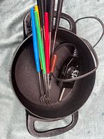 Top view of pot showing six forks and temperature probe