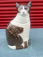 Full view of ceramic cat jar showing painted details and overall condition