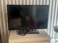 Front view of LG flat screen monitor on stand with cable