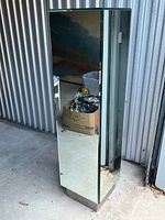 Front and side view of mirrored pedestal showing reflective panels and base