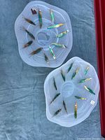 Two clear painted glass plates laid flat showing size difference and motif